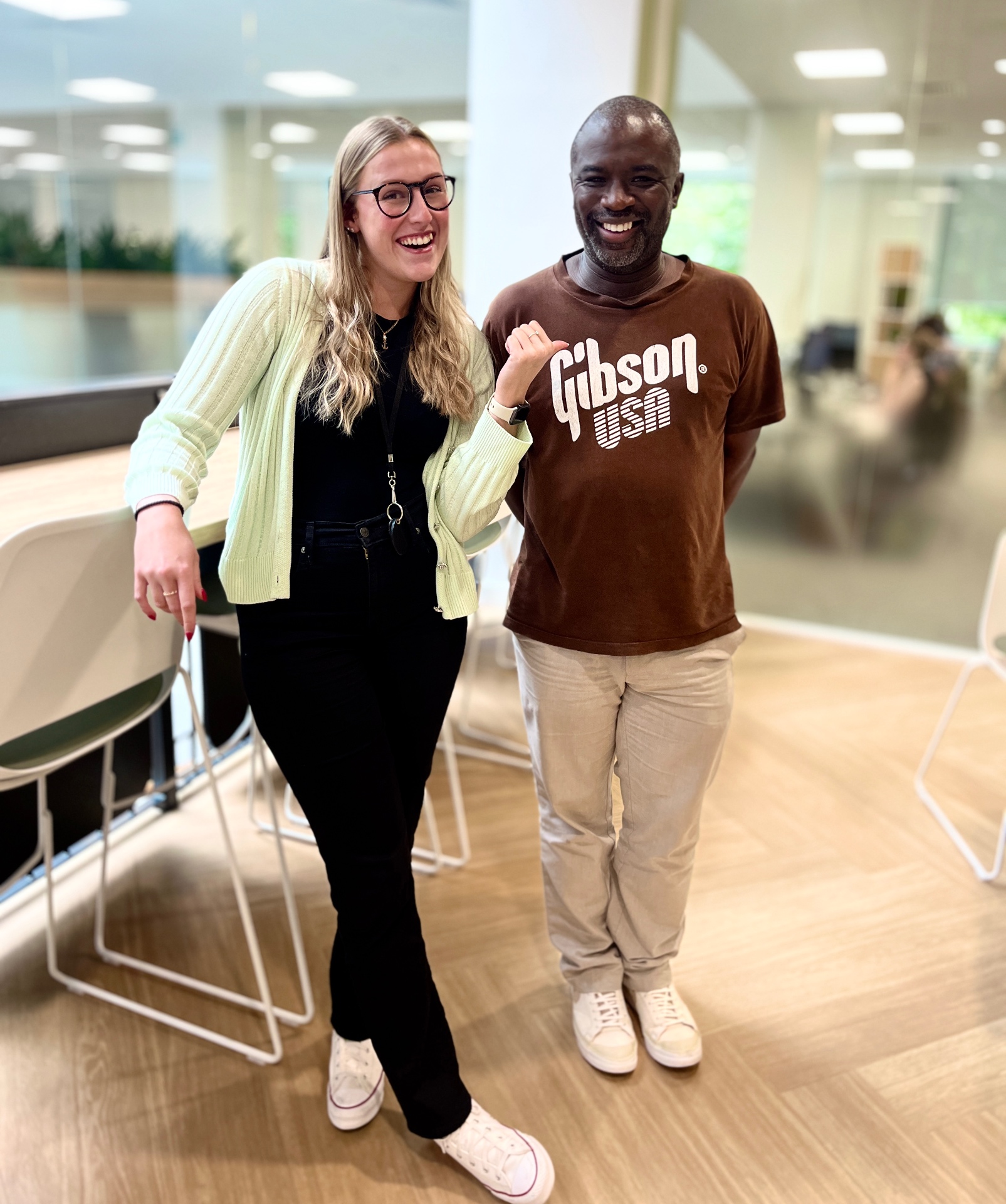 Leah with a legal community member smiling together in a modern office