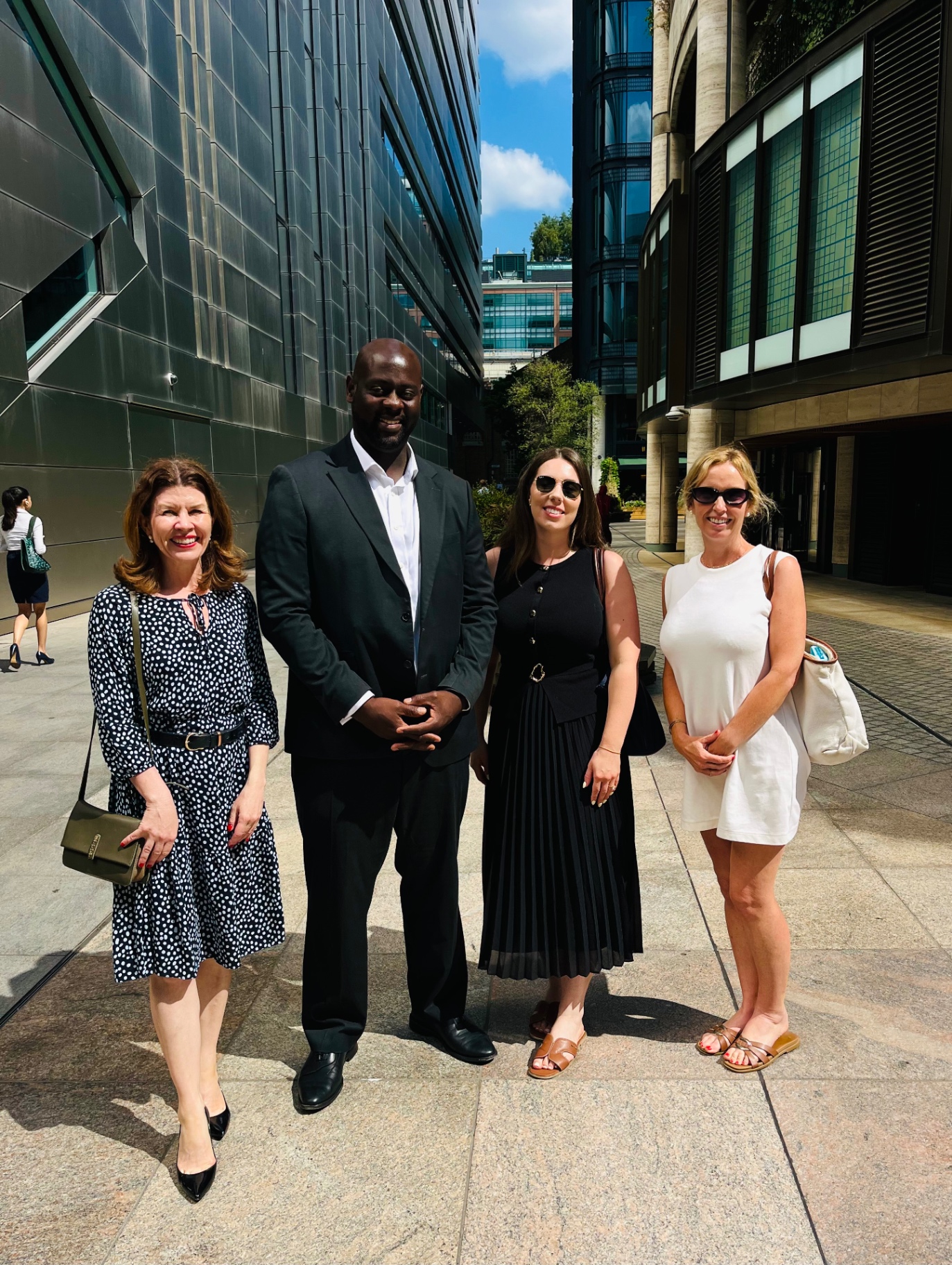 Leah with three legal community members standing together outside a City of London office building on a sunny day